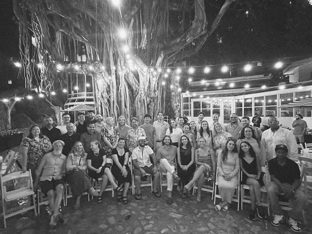 Team of Bodybio group black and white photo under tree lights